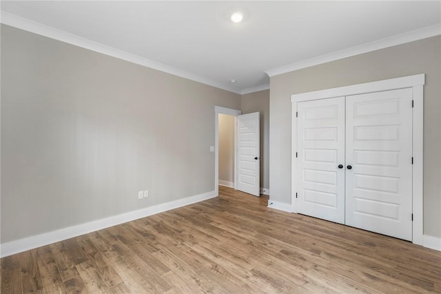 327 Thompson Rd, Taylors, SC 29687 - unfurnished bedroom with crown molding, baseboards, wood finished floors, and a closet