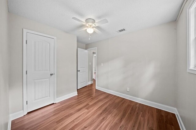 1922 Dobbins Ave, Anderson, SC 29625 - unfurnished bedroom featuring light wood finished floors, baseboards, a textured ceiling, and a ceiling fan