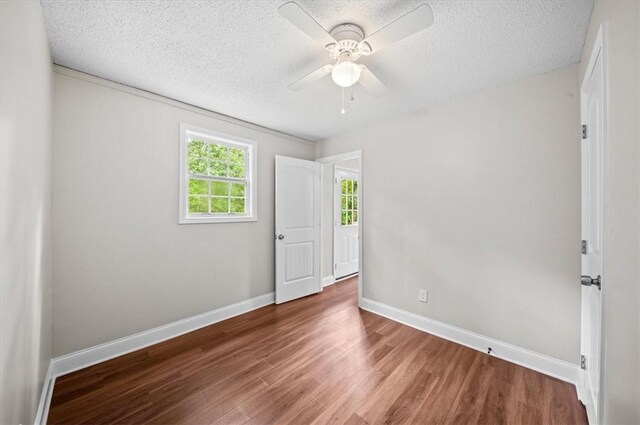 1922 Dobbins Ave, Anderson, SC 29625 - spare room with wood finished floors, ceiling fan, baseboards, and a textured ceiling