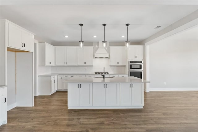 1002 Princeton Rd, Williamston, SC 29697 - kitchen featuring premium range hood, baseboards, white cabinetry, light countertops, and recessed lighting