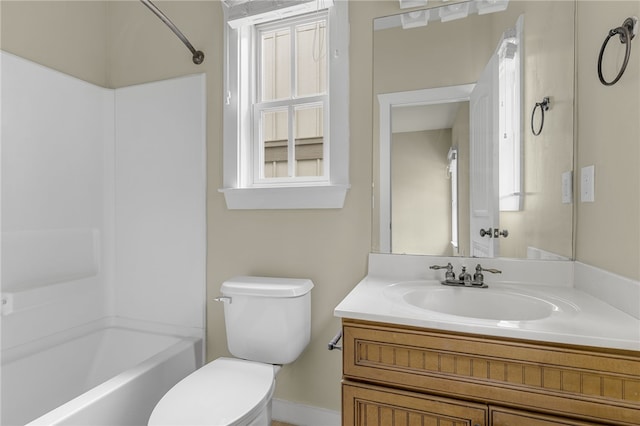 bathroom featuring toilet, vanity, healthy amount of natural light, and baseboards