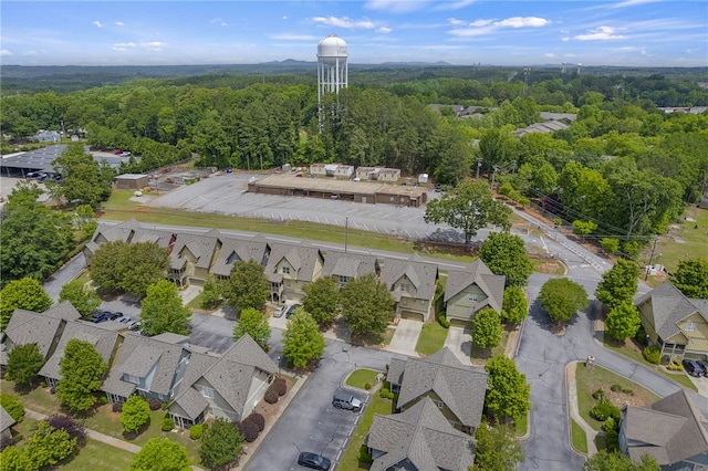 aerial perspective of suburban area featuring a heavily wooded area