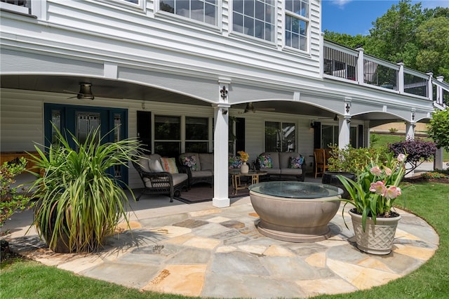 view of patio featuring a ceiling fan, a balcony, and an outdoor hangout area