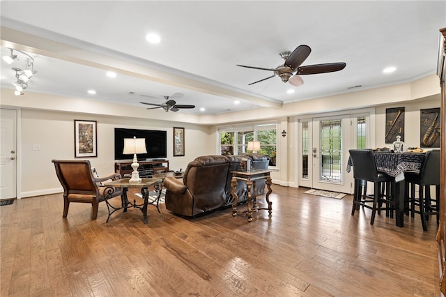 living room with ceiling fan, wood-type flooring, ornamental molding, and recessed lighting