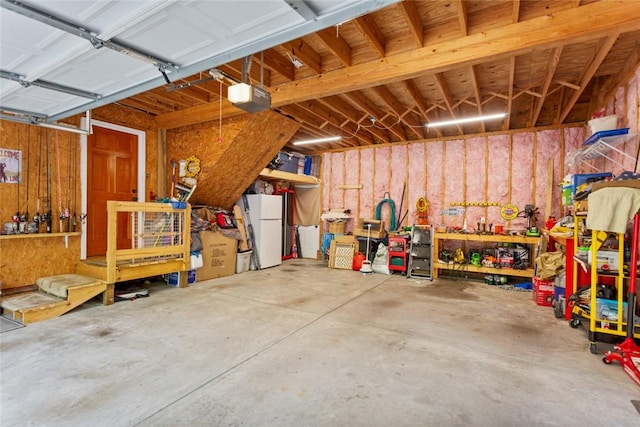 310 Fernwood Dr, Salem, SC 29676 - garage with freestanding refrigerator, a garage door opener, and a workshop area