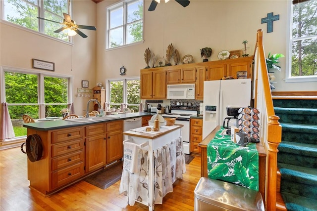 310 Fernwood Dr, Salem, SC 29676 - kitchen with white appliances, a ceiling fan, a sink, light wood-style flooring, and a high ceiling