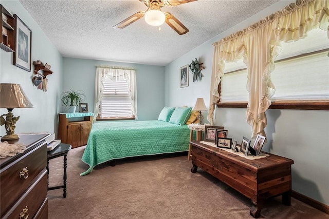 bedroom with a textured ceiling, carpet, and a ceiling fan