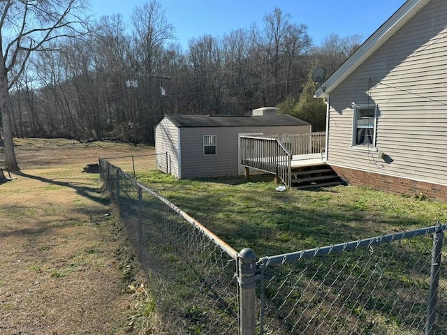 view of yard with a wooden deck and an outbuilding