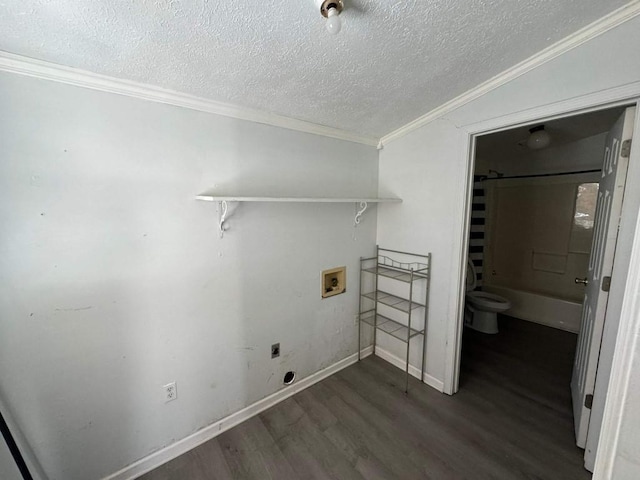 washroom with hookup for a washing machine, a textured ceiling, wood finished floors, hookup for an electric dryer, and ornamental molding
