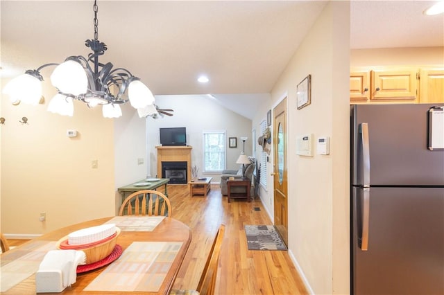 238 Jenkins Mill Dr, Westminster, SC 29693 - dining area with a glass covered fireplace, light wood-type flooring, vaulted ceiling, recessed lighting, and a chandelier