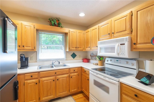 238 Jenkins Mill Dr, Westminster, SC 29693 - kitchen with white appliances, a sink, light countertops, recessed lighting, and light wood-style flooring