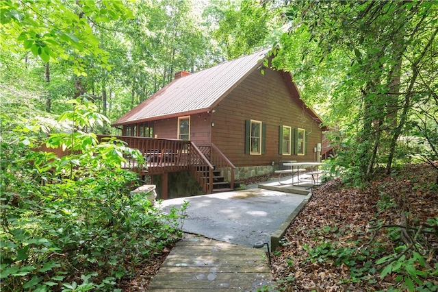 238 Jenkins Mill Dr, Westminster, SC 29693 - view of front of property with a wooden deck, a patio, metal roof, and a chimney