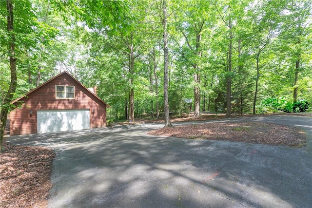 238 Jenkins Mill Dr, Westminster, SC 29693 - view of home's exterior with asphalt driveway, a detached garage, and a wooded view