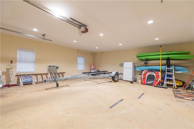 238 Jenkins Mill Dr, Westminster, SC 29693 - garage featuring freestanding refrigerator, a garage door opener, and recessed lighting