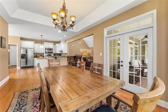 dining room with a chandelier, baseboards, light wood-type flooring, recessed lighting, and french doors