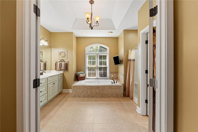 bathroom with tiled tub, vanity, a shower with shower curtain, tile patterned flooring, and a tray ceiling