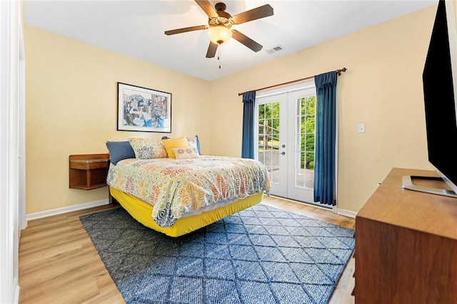 bedroom with access to exterior, light wood-style flooring, and baseboards