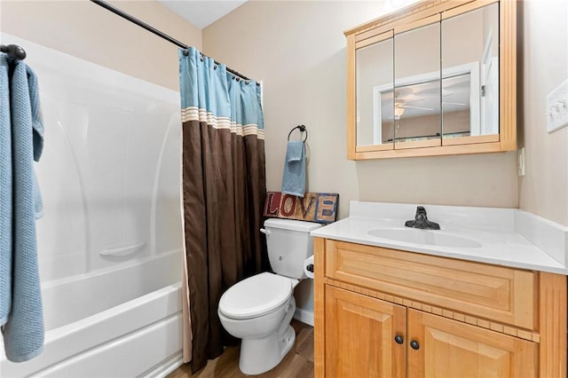 bathroom with wood finished floors, toilet, vanity, and shower / bath combination with curtain