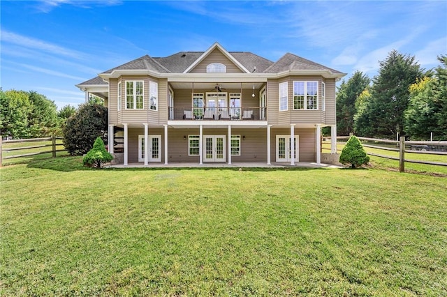 rear view of property featuring french doors, ceiling fan, and a patio area