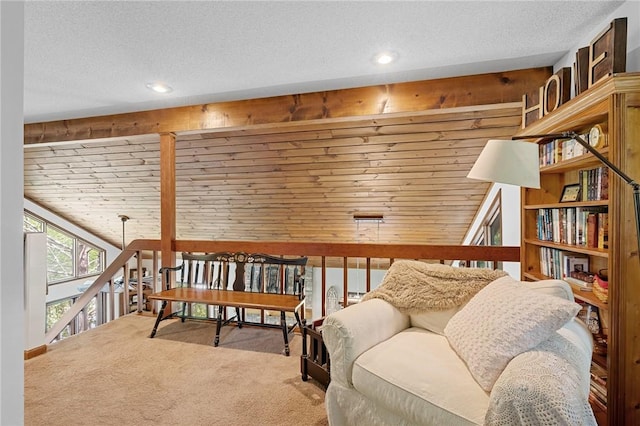 sitting room with carpet flooring, recessed lighting, an upstairs landing, and a textured ceiling