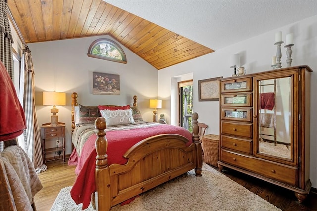 bedroom featuring lofted ceiling, wood finished floors, and wooden ceiling