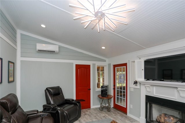 371 Store Rd, Easley, SC 29640 - living area featuring an AC wall unit, wood finished floors, a fireplace, lofted ceiling, and a chandelier