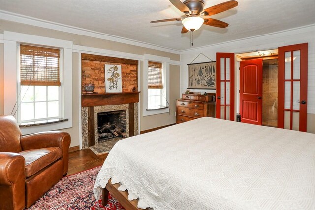 371 Store Rd, Easley, SC 29640 - bedroom with crown molding, multiple windows, wood finished floors, a fireplace, and a ceiling fan