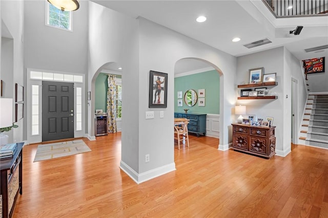 103 Crepe Myrtle Ln, Anderson, SC 29625 - foyer featuring arched walkways, light wood finished floors, stairway, a high ceiling, and recessed lighting