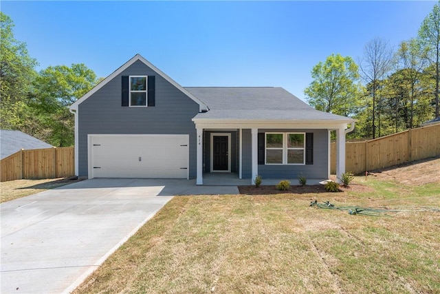 traditional-style house featuring covered porch, concrete driveway, and an attached garage