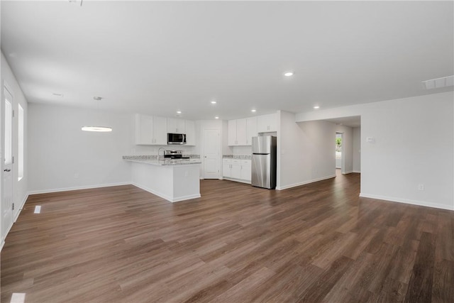 unfurnished living room featuring baseboards, recessed lighting, and dark wood finished floors