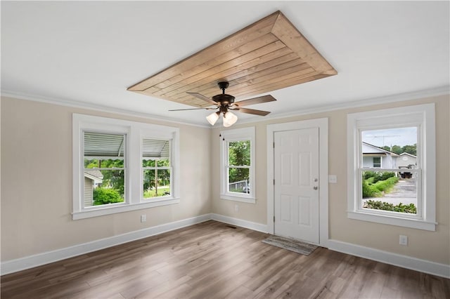 foyer entrance with crown molding, a ceiling fan, baseboards, and wood finished floors