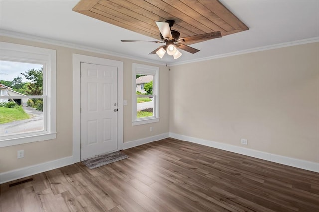 foyer entrance with baseboards, wood finished floors, crown molding, and a ceiling fan