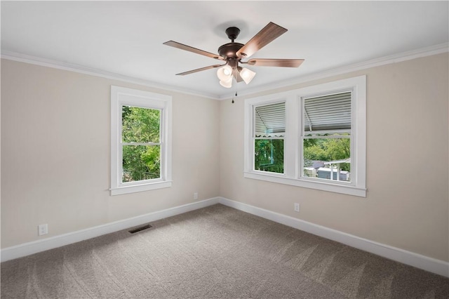 unfurnished room with baseboards, ornamental molding, carpet flooring, and a ceiling fan