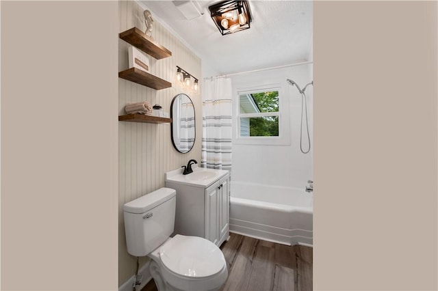 full bathroom with wood finished floors, toilet, shower / bathtub combination with curtain, and vanity