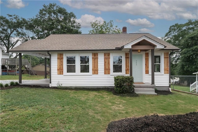 view of front of home with a chimney and roof with shingles