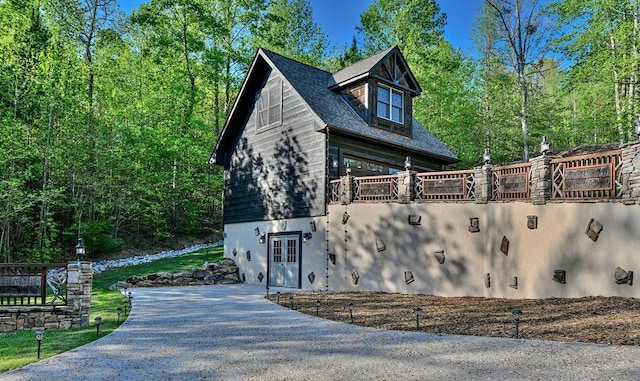 view of side of property featuring a balcony and french doors