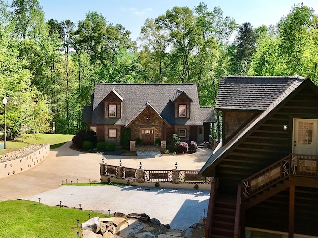 back of property with stairway and stone siding