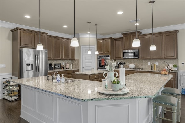 103 James Lake Way, Easley, SC 29642 - kitchen with stainless steel appliances, a spacious island, a sink, dark wood finished floors, and crown molding