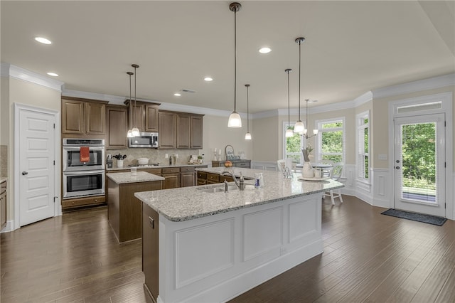 103 James Lake Way, Easley, SC 29642 - kitchen featuring a sink, a spacious island, stainless steel appliances, dark wood-type flooring, and wainscoting