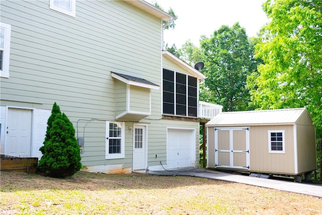608 Mckinney Way, Westminster, SC 29693 - back of house featuring a shed, an attached garage, a sunroom, and an outbuilding