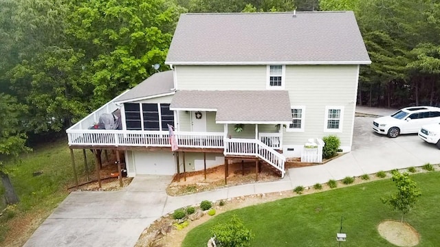 608 Mckinney Way, Westminster, SC 29693 - back of house featuring concrete driveway, a garage, roof with shingles, a lawn, and a wooden deck