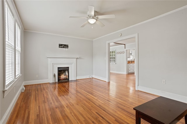 117 Henry Ave, Anderson, SC 29625 - unfurnished living room with light wood finished floors, a ceiling fan, plenty of natural light, a brick fireplace, and crown molding