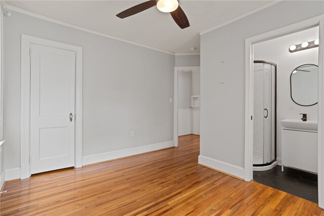 117 Henry Ave, Anderson, SC 29625 - unfurnished bedroom with light wood finished floors, crown molding, a sink, baseboards, and ceiling fan