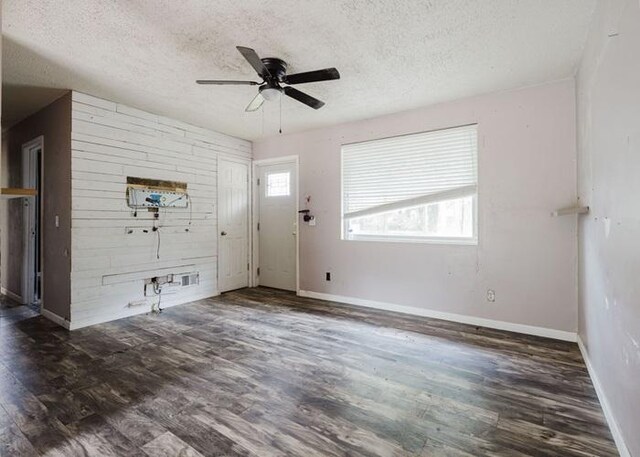 4709 Mcdonald Ave, West Columbia, SC 29172 - unfurnished living room featuring a textured ceiling, wood finished floors, a ceiling fan, and baseboards