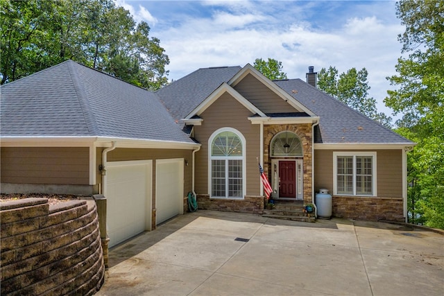 117 W Waters Edge Ln, West Union, SC 29696 - traditional-style house featuring a garage, concrete driveway, a shingled roof, and stone siding