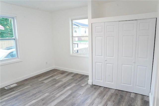 221 Foster St, Anderson, SC 29625 - unfurnished bedroom featuring wood finished floors, a closet, and baseboards