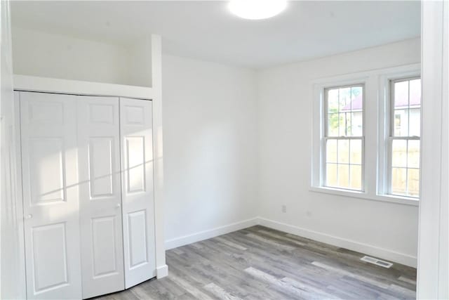 221 Foster St, Anderson, SC 29625 - unfurnished bedroom featuring wood finished floors, a closet, and baseboards