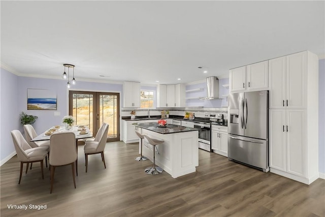 11 Arlington Rd, Greer, SC 29651 - kitchen featuring appliances with stainless steel finishes, wall chimney exhaust hood, dark countertops, a center island, and white cabinets