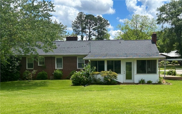 502 Cheyenne St, Anderson, SC 29626 - back of house featuring a chimney, a lawn, and brick siding