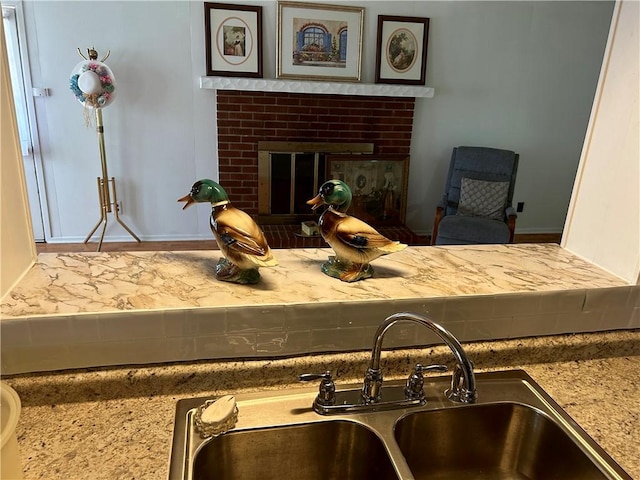 502 Cheyenne St, Anderson, SC 29626 - detailed view of a sink, a brick fireplace, and baseboards